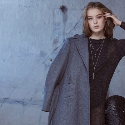 Portrait of modern female in a grey coat.