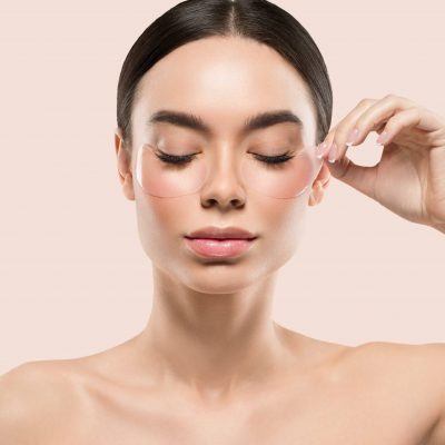 Eyes mask woman face cosmetic. Color background. Pink.