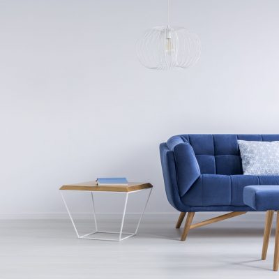 Blue sofa and bench in white trendy lounge